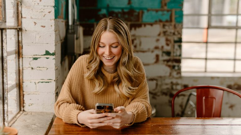 Woman reading about GLP-1 myths on her phone at the kitchen table